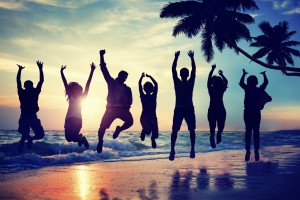 Young People Jumping with Excitement on a Beach